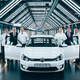 Engineers and executives posing with a white VW e-Golf